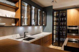 A kitchen featuring wooden cabinets and a stainless steel sink showcasing a warm and inviting atmosphere