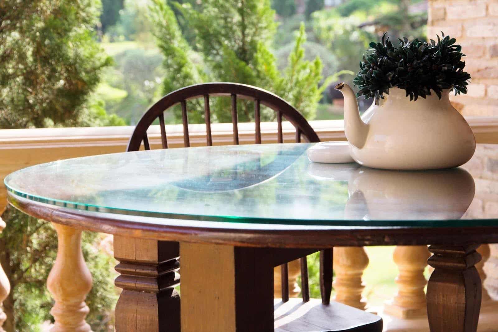 A wooden table featuring a decorative vase of vibrant flowers adding a touch of elegance to the setting