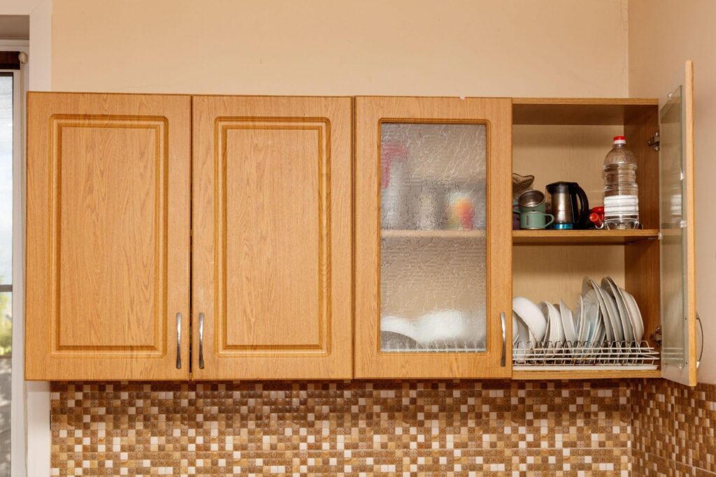 A kitchen featuring wooden cabinets and a modern dishwasher showcasing a warm and inviting cooking space