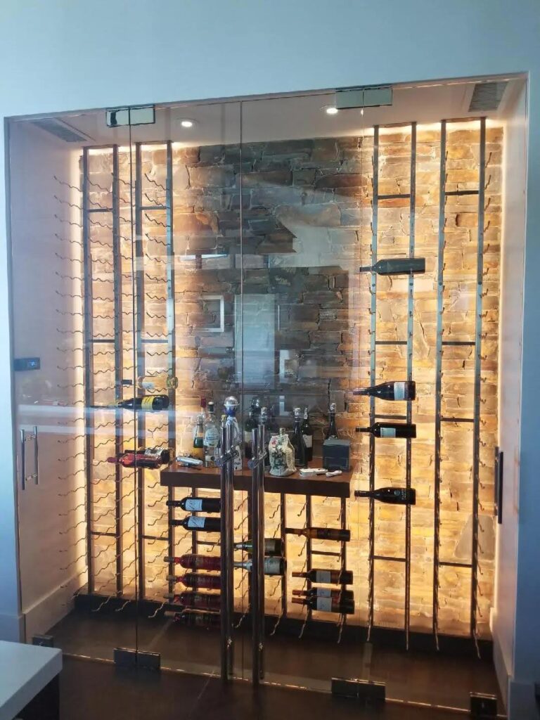 A wine room featuring glass doors and neatly arranged shelves filled with various wine bottles